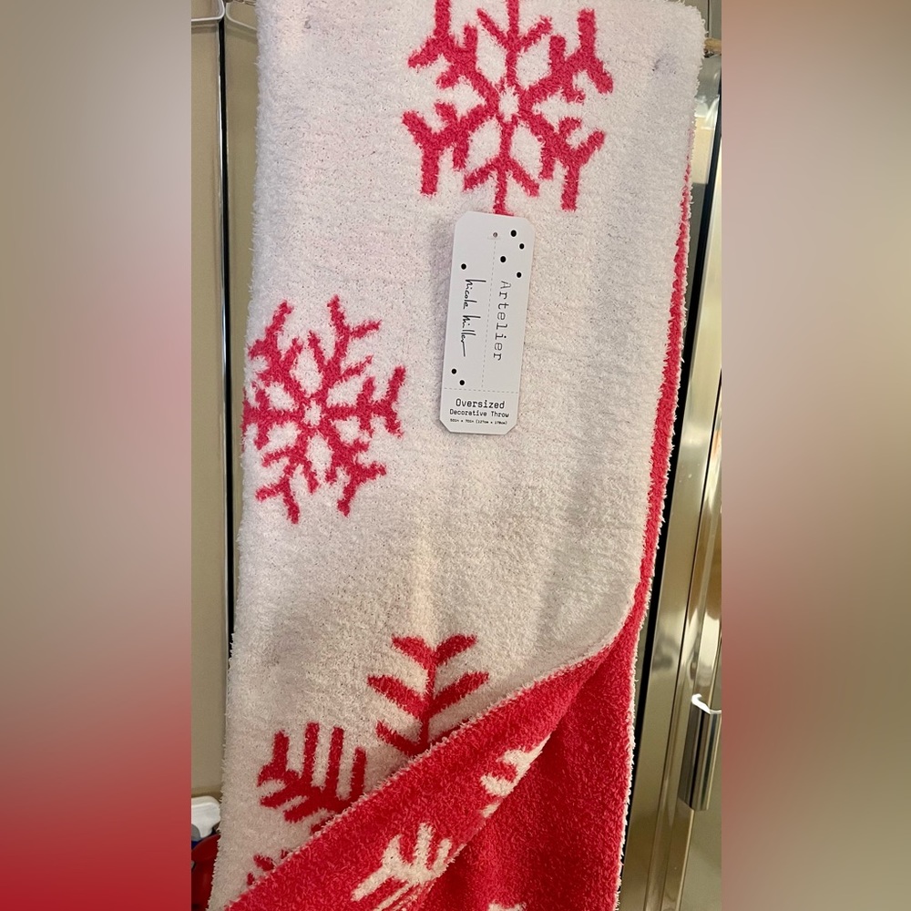 Soft cozy reversible pink snowflake throw.